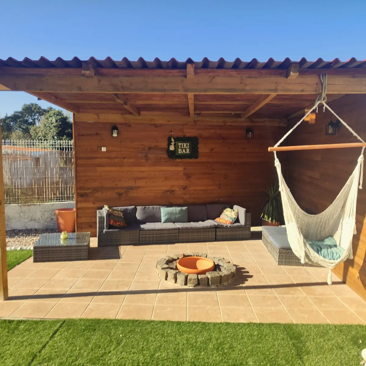 Outdoor lounge with hammock and fire pit