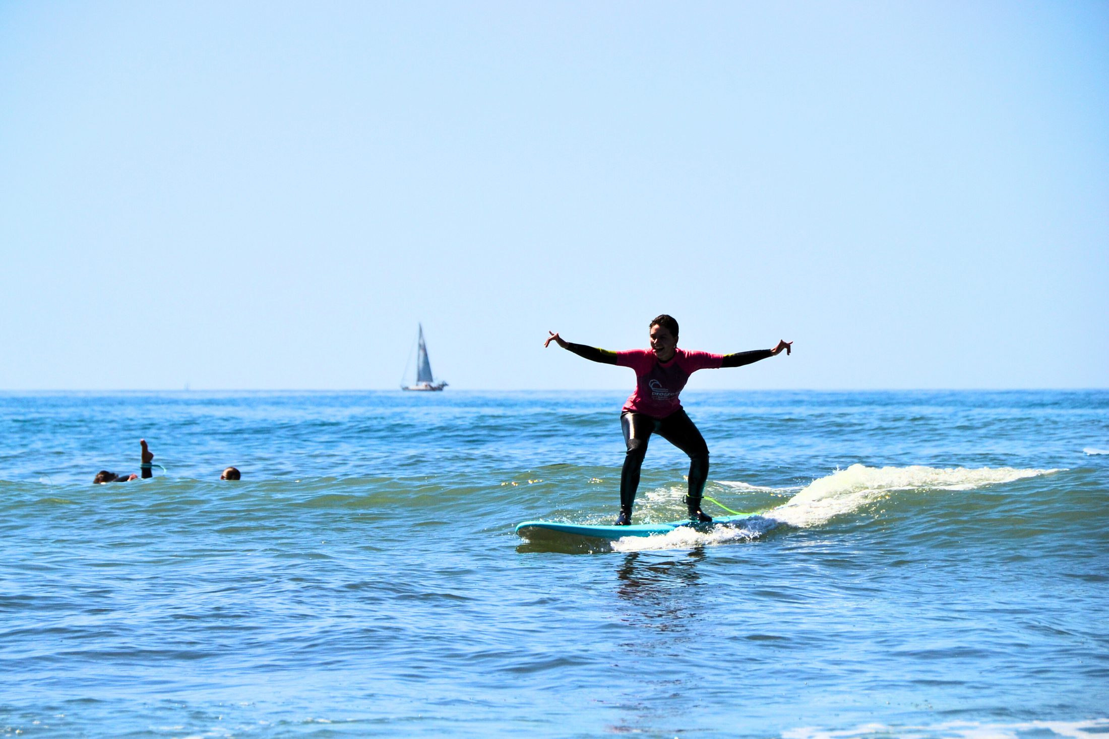 Small group walking the Ericeira cliffs with surfboards at golden hour